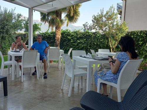 a group of people sitting at tables on a patio at B&B TENUTA BIANCA in Oliveto Citra