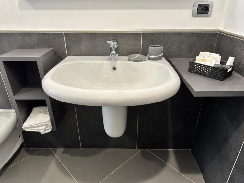 a bathroom with a white sink in a room at All'ombra della magnolia in Selvazzano Dentro