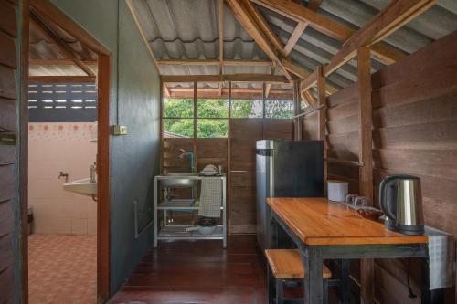 uma cozinha com um balcão de madeira e um frigorífico em Serene Escape in Pai em Ban Wiang Nua