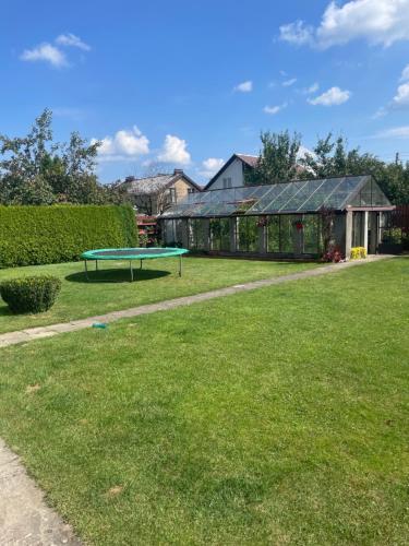 a house with a ping pong table in the yard at Guest House Vilnius in Vilnius