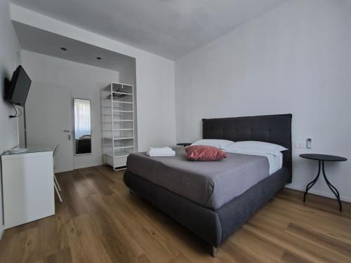 a bedroom with a large bed and a table at Faber Home in Conversano