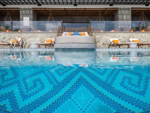 a large swimming pool with a bed and chairs at HL Houses Apec Phú Yên in Tuy Hoa
