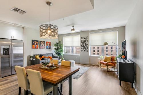 a dining room and living room with a table and chairs at New Renovated Condo in the Heart of NOLA in New Orleans