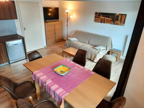 un salon avec une table, des chaises et un canapé dans l'établissement Isola 2000 duplex 7P vue pistes dernier etage, à Isola 2000