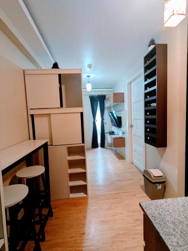 a room with a desk and some shelves at REI365 Condotel in Davao City