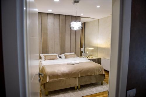 a bedroom with a large bed and a mirror at Villa Dolce Vita in Međugorje