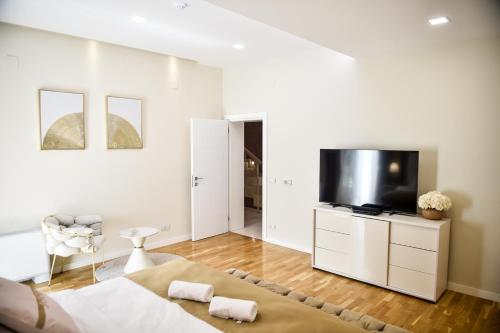 a bedroom with a bed and a flat screen tv at Villa Dolce Vita in Međugorje