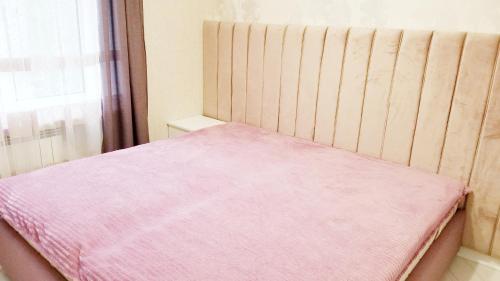 a bedroom with a bed with a pink blanket at Very beautiful apartment in Komitas avenue in Yerevan