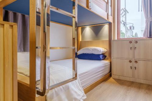 a bunk bed room with two bunk beds in it at เดอะซีน คาบาน่า บีช รีสอร์ท ขนอม The Scene Cabana Beach Resort Khanom in Ban Plau