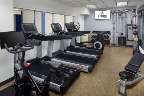 a gym with several tread machines in a room at Hilton Chicago/Northbrook in Northbrook