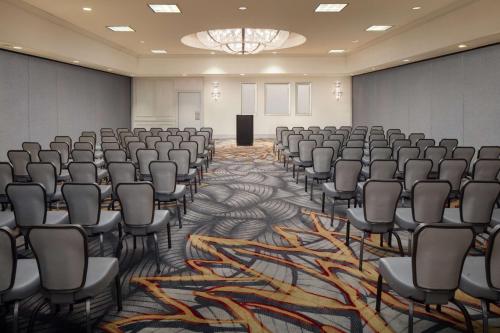 a conference room with chairs and a stage in it at Hilton Chicago/Northbrook in Northbrook