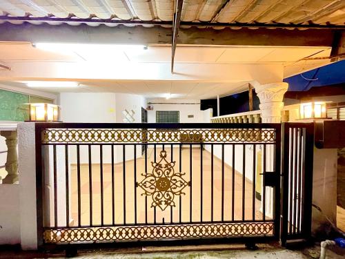 a gate in the middle of a house at Home in Sepang, Homestay Mokhzan in Sepang