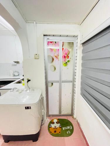 a small bathroom with a sink and a door at Home in Sepang, Homestay Mokhzan in Sepang