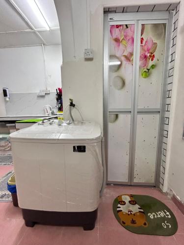 a bathroom with a bath tub next to a refrigerator at Home in Sepang, Homestay Mokhzan in Sepang