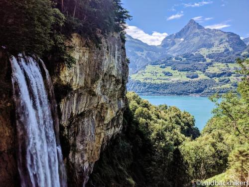 a waterfall on the side of a cliff next to a lake at Wohnung in den Bergen - 1 Stunde von Zürich in Filzbach