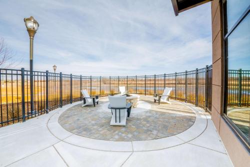 a patio with chairs and a table and a fence at Hampton Inn By Hilton Wichita Northwest in Wichita