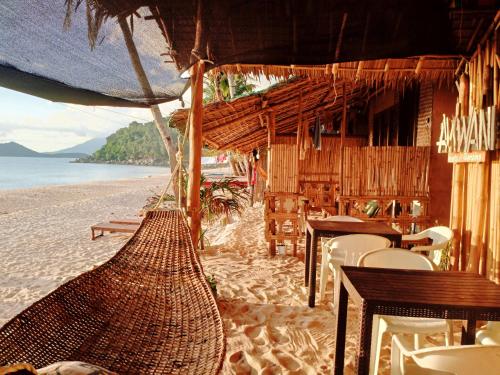 a resort with a hammock on the beach at Amwani Camping Site in San Vicente
