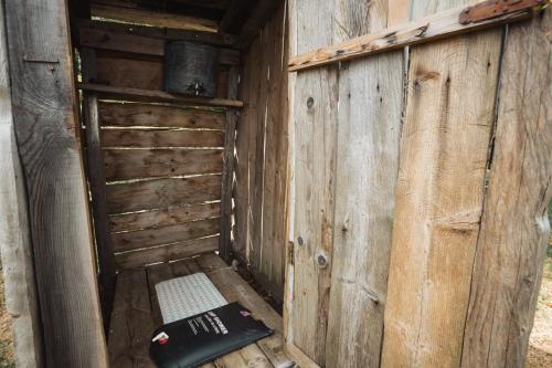 an outhouse with a bench in the side of it at Household Šain in Pluzine