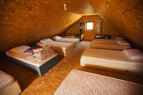 a attic room with a bunch of beds in it at Household Šain in Pluzine