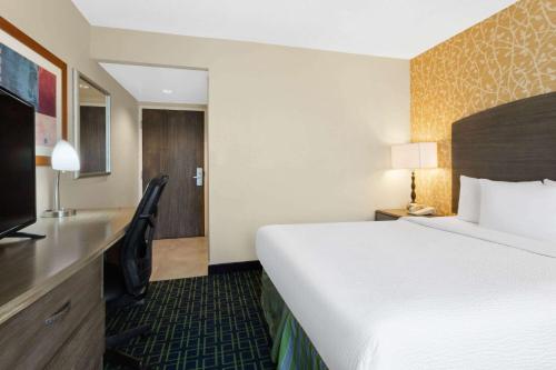 a hotel room with a large bed and a television at Wyndham Garden Monterrey Aeropuerto in Monterrey
