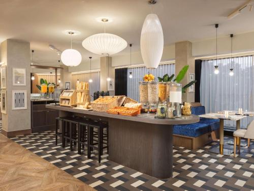 a lobby with a counter with food on it at Mercure London Earls Court in London