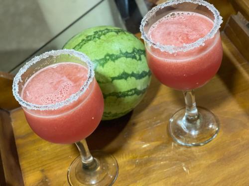two drinks in glasses next to a watermelon at Namaya Nature in Kandy
