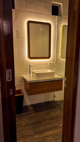 a bathroom with a sink and a mirror at Villa Tegal lovina in Buleleng