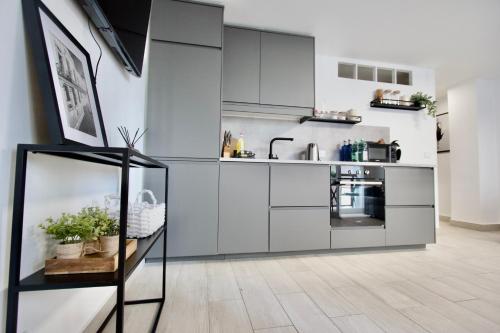 a kitchen with gray cabinets and a counter at Vanili Santa Pola in Santa Pola