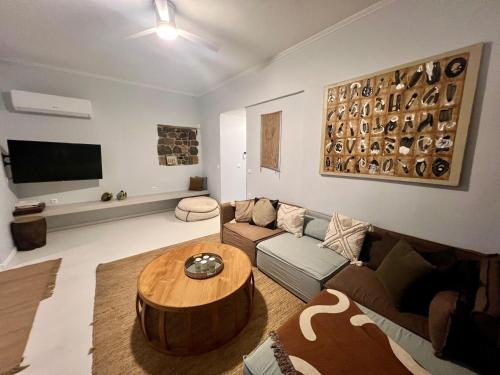 a living room with a couch and a coffee table at Evia Escape - Beachfront villa in Skála