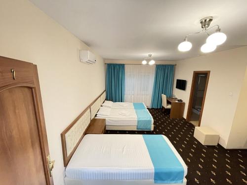 a hospital room with two beds and a desk at Hostel Paltinis in Hunedoara