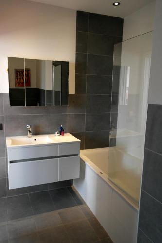a bathroom with a white sink and a shower at Vista da Sogno in San Siro