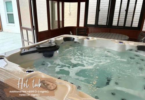 a jacuzzi tub in a house with green water at 5BR Home 3 mins Wiley Post, Sleeps 12 #CO in Bethany