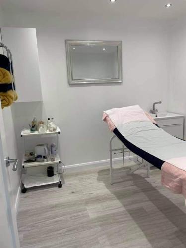 a hospital room with a bed and a sink at Drummond Hotel in Ballykelly