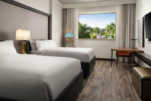 a hotel room with two beds and a window at Renaissance Fort Lauderdale West Hotel in Plantation