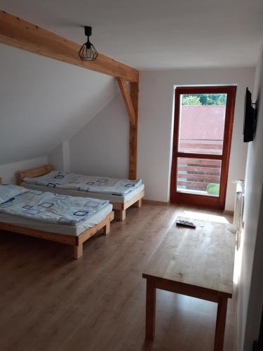 a room with two beds and a window at Agroturystyka Izby in Izby
