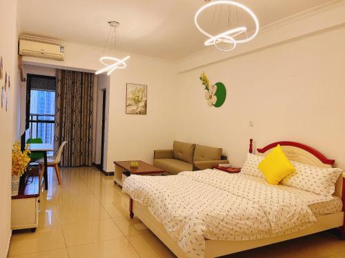 a bedroom with a bed and a couch at Lan House Youth Apartment in Guangzhou