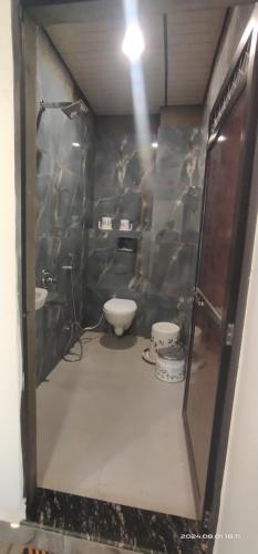 a bathroom with two sinks and a toilet in a room at Hotel nandmani in Ujjain
