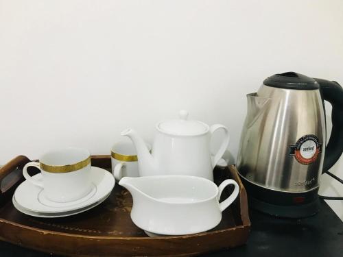 a tray with a tea pot and cups and a kettle at The Velvet Dambulla in Dambulla