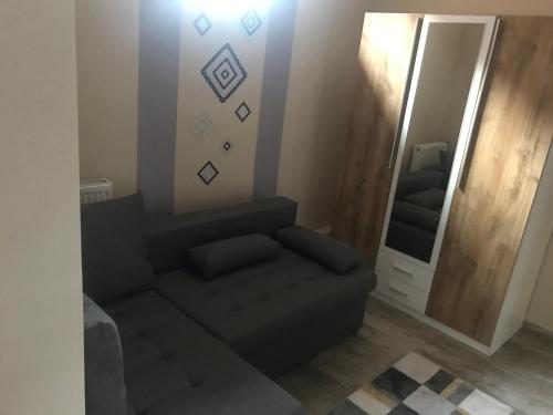a living room with a couch and a mirror at Eperjes Ház in Budapest
