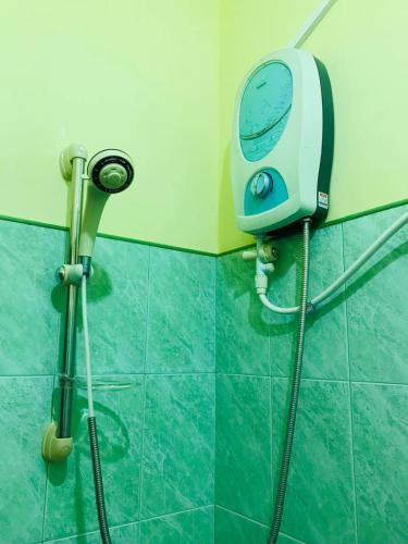 a shower in a bathroom with a blow dryer at The Velvet Dambulla in Dambulla