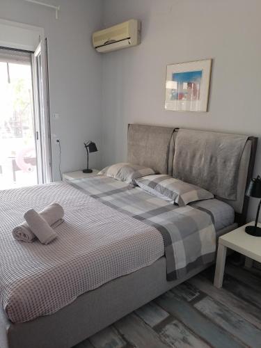 a bed with two towels on it in a bedroom at 2SEA VILLA Nea Potidea CHALKIDIKI in Nea Potidaea