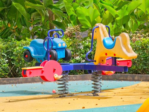 two toy cars on a swing in the sand at Lakwatsero Caviteño Suites in Trece Martires