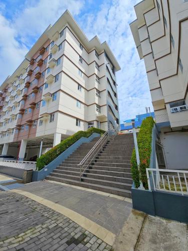 a building with stairs in front of a building at Lakwatsero Caviteño Suites in Trece Martires
