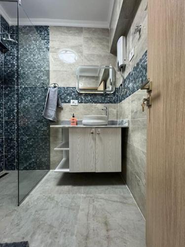 a bathroom with a sink and a shower at CC Luxurious Apartment in Hurghada