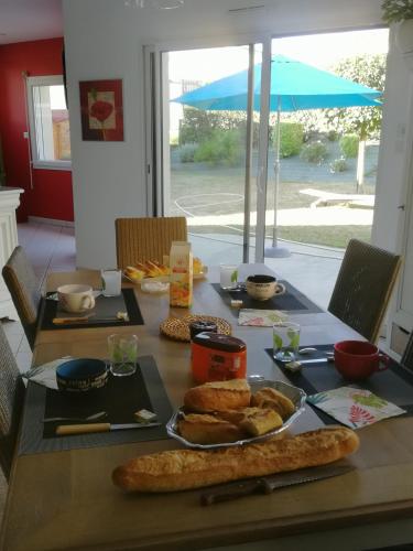 une table avec une assiette de nourriture dessus dans l'établissement Chambres d'hôtes chez Nanou la Puyfolaise - 1 ou 2 chambres, à Saint-Laurent-sur-Sèvre