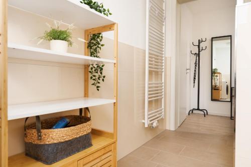 a room with white shelves and a hallway at Idyllische Ferienwohnung am Schaalsee - Natur und Erholung pur in Zarrentin