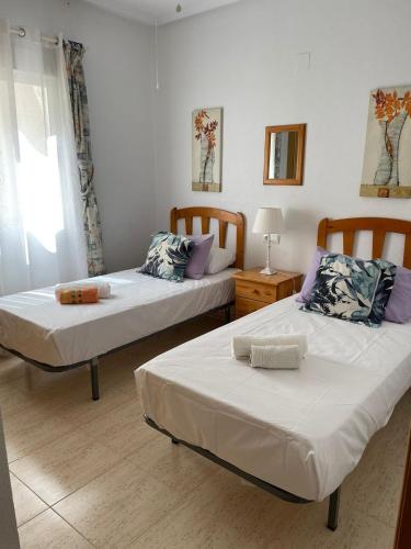 a bedroom with two beds and a window at Appartement Dolores in Dolores