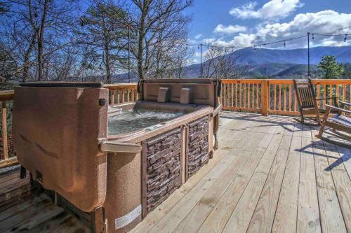 a hot tub on a wooden deck with a grill at Great views-King beds-WIFI-ample parking-games in Sevierville