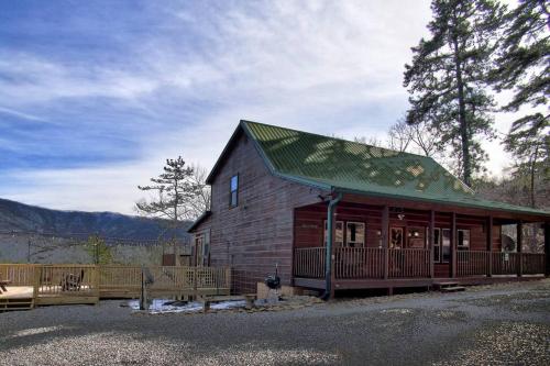 a large wooden cabin with a green roof at Great views-King beds-WIFI-ample parking-games in Sevierville