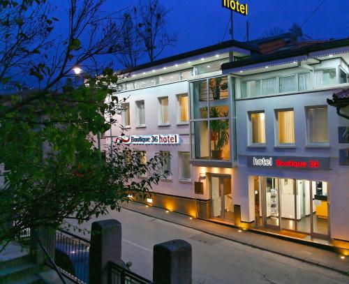 a building with signs on the side of a street at Hotel Boutique 36 in Sarajevo